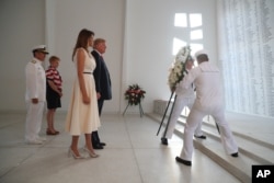 U.S. President Donald Trump and first lady Melania Trump lay a wreath at the USS Arizona Memorial in Pearl Harbor, Honolulu, Hawaii, Nov. 3, 2017. Trump begins a five-country trip through Asia traveling to Japan, South Korea, China, Vietnam and the Philippines.