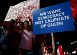 Supporters of Turkish President Recep Tayyip Erdogan hold a placard during a pro-government rally at Kizilay main square, in Ankara, Turkey, July 20, 2016.