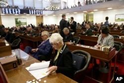 FILE - Rep. Julia Craven Howard, R-Davie, foreground, and other North Carolina lawmakers gather for a special session regarding the "bathroom bill," March 23, 2016.