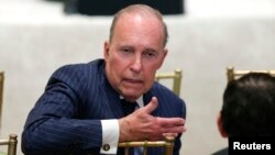 Larry Kudlow, director of the National Economic Council, speaks with another attendee as U.S. President Donald Trump hosts a joint press conference with Japan's Prime Minister Shinzo Abe at Trump's Mar-a-Lago estate in Palm Beach, Florida, April 18, 2018.