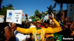 Supporters of former South African president Jacob Zuma wait outside the high court in Durban, South Africa, April 6, 2018.