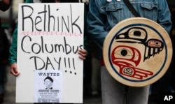 FILE - Demonstrators stand during a Native American protest against Columbus Day.