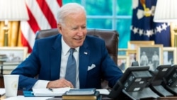 U.S. President Joe Biden speaks on the phone with French President Emmanuel Macron from the Oval Office of the White House in this official White House handout photo released after the call in Washington, September 22, 2021.