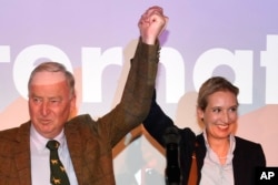 FILE - AfD top candidates Alexander Gauland, left, and Alice Weidel celebrate with their supporters during the election party of the nationalist 'Alternative for Germany', AfD, in Berlin, Sept. 24, 2017.