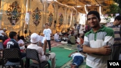 Fifteen-year-old Abdulrahman Usama has been staying in this tent for nearly a month and says he won't go back to school until the former president is reinstated. (Heather Murdock for VOA)