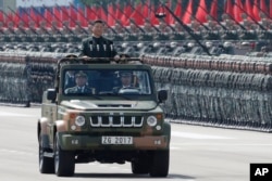 FILE - Chinese President Xi Jinping inspects the People's Liberation Army of the Hong Kong Garrison at the Shek Kong Barracks in Hong Kong, June 30, 2017.