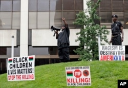 People participate in a rally against racism, injustice and white supremacy, in Perk Park, before the Republican National Convention in Cleveland, Ohio, July 16, 2016.