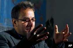 FILE - Jose Pablo Baryabar, a forensic anthropologist from the International Committee of the Red Cross, speaks during an interview in Paris, Nov. 20, 2018.