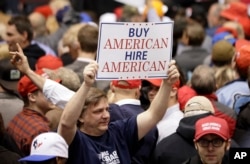 A supporter of President Donald Trump holds up a sign at a rally, March 15, 2017, in Nashville, Tennessee.
