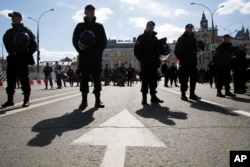 Police officers stay guard during an opposition rally in Moscow downtown, Russia, May 6, 2017. People gather for the rally against the Kremlin and demanding the release of political prisoners, five years since the opposition protest at May 6, 2012, that e