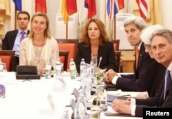 European Union foreign policy chief Federica Mogherini, left, U.S. Secretary of State John Kerry, third from left, Under Secretary for Political Affairs Wendy Sherman and British Foreign Secretary Philip Hammond, right, wait for the start of a meeting in