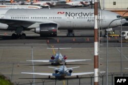 A Boeing 777 from Russia's Nordwind Airlines remains parked on the runway at La Guaira airport, near Caracas on Jan. 30, 2019.