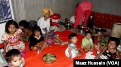 FILE - Some Rohingya women and children in an unidentified refugee colony in West Bengal, eastern India, April 2018.