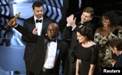FILE - Writer and director Barry Jenkins of "Moonlight" holds up the Best Picture Oscar at the Dolby Theatre in Los Angeles, Feb. 26, 2017.