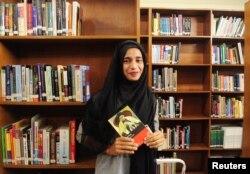 Formin Akter holds a copy of the novel Jane Eyre, which she says is her new favorite book, inside the library of the Asian University for Women in Chittagong, Bangladesh, Dec. 4, 2018.