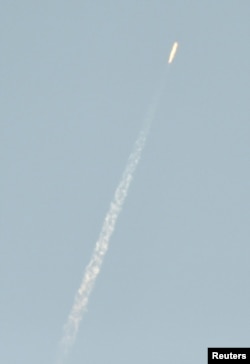 A flying object soars into the air above North Korean territory as seen from the Chinese border city of Dandong, in this photo taken by Kyodo February 7, 2016.