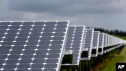 FILE - Some of the more than 37,000 solar panels gather sunlight at the Space Coast Next Generation Solar Center, in Merritt Island, Florida, May 13, 2015.