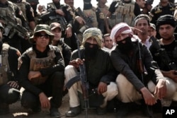 Soldiers from the 1st Battalion of the Iraqi Special Operations Forces wear fake beards during a training exercise to prepare for the operation to retake Mosul from IS, in Baghdad, Iraq, Sept. 2016