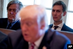 FILE - Then-White House Senior Advisers Steve Bannon, left, and Jared Kushner, listen as President Donald Trump speaks during a Cabinet meeting, June 12, 2017, in the Cabinet Room of the White House in Washington.