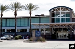 A Greyhound bus terminal is shown, March 15, 2019, in Phoenix. Greyhound Lines Inc. is no longer allowing U.S. authorities to drop off immigrant families inside bus stations, forcing those who have been released from custody to wait outside until they have a ticket.