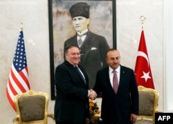 U.S. Secretary of State Mike Pompeo, left, meets with Turkish Foreign Minister Mevlut Cavusoglu in Ankara, Oct. 17, 2018.
