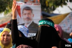 At a pro-Morsi rally in Cairo, mothers say they bring their children to demonstrations to teach them to fight for their rights. (H. Elrasam for VOA)