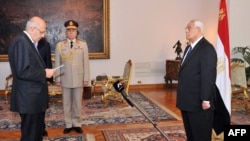 A handout picture released by the Egyptian Presidency shows Egyptian leader Mohamed ElBaradei (L) being sworn in as Egypt's interim vice president for foreign relations, in front of Egypt's interim president Adly Mansour (R), in Cairo on Jul. 14, 2013.