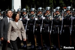 FILE - Taiwanese President Tsai Ing-wen inspects honour guard before a ceremony to mark the 92nd anniversary of the Whampoa Military Academy, in Kaohsiung, southern Taiwan, June 16, 2016.