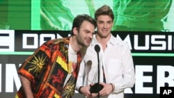 Alex Pall, left, and Andrew Taggart, of The Chainsmokers, accept the award for favorite artist - electronic dance music at the American Music Awards at the Microsoft Theater, Nov. 20, 2016, in Los Angeles.