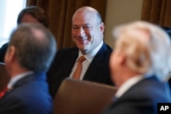 FILE - President Donald Trump speaks to outgoing White House chief economic adviser Gary Cohn during a cabinet meeting at the White House, March 8, 2018.