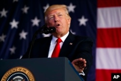 FILE - President Donald Trump speaks to U.S. military troops at Naval Air Station Sigonella, Italy, May 27, 2017