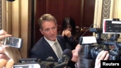 Senator Jeff Flake reacts during a confrontation with a protester in an elevator in Washington, D.C., Sept. 28, 2018 in this still image obtained from a social media video.