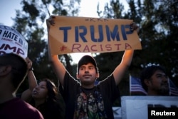 FILE - People protest outside the Luxe Hotel, where Republican presidential candidate Donald Trump was expected to speak in Brentwood, Los Angeles, California, July 10, 2015.