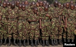 FILE - Kenya Defense Forces pay respects to the Kenyan soldiers serving in the African Union Mission in Somalia (AMISOM), who were killed in El Adde during an attack, at a memorial mass at the Moi Barracks in Eldoret, Jan. 2016.