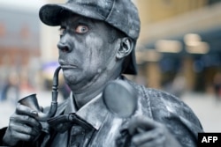 A performer poses as a Sherlock Holmes human statue in London, September 2013.
