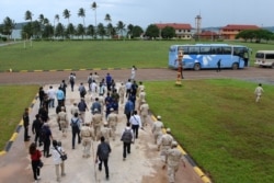 FILE - Cambodia naval personnel walk with journalists during a government organized media tour to the Ream naval base in Preah Sihanouk province on July 26, 2019.