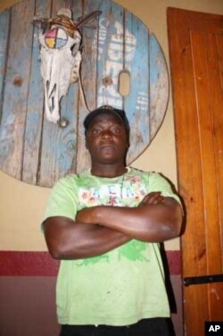 Although he prefers cooking, the muscular Aaron Kalimanjira works as a doorman when the Kaapsche Hoop bar turns into a nightclub on weekends