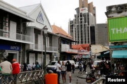 FILE - A view of the Commercial Bank of Mauritius office, left, in Port Louis on the Indian Ocean island of Mauritius, Aug. 5, 2015.