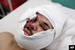 Hasib Sadat, an Afghan journalist injured from yesterday's suicide attack near the Russian Embassy, lays on a bed at a hospital in Kabul, Afghanistan, Jan. 21, 2016.