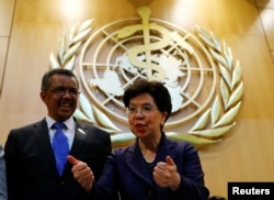 FILE - Outgoing Director-General Margaret Chan, right, poses with Tedros Adhanom Ghebreyesus after his election as Director General of the World Health Organization (WHO) during the 70th World Health Assembly in Geneva, Switzerland, May 23, 2017.