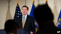 FILE - Comey makes a statement at FBI Headquarters in Washington, Tuesday, July 5, 2016.