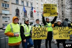 People participate in a "yellow vests" protest in front of the French Consulate in New York, Dec. 22, 2018.