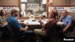 People talk during a show at the WAPA 680 radio station, in San Juan, Puerto Rico, Sept. 27, 2017.