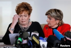 FILE - Beverly Young Nelson, left, reacts as she reads a statement to reporters with attorney Gloria Allred during a news conference announcing new allegations of sexual misconduct against Alabama Republican congressional candidate Roy Moore, in New York, Nov. 13, 2017.