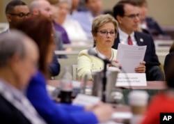 Indiana Secretary of State Connie Lawson reads notes that were handed out on voter registration during the National Association of Secretaries of State conference in Indianapolis, July 8, 2017.