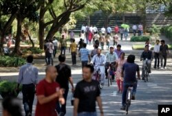 FILE - ﻿employees of Infosys Technologies, the Indian technology outsourcing giant, move inside the company headquarters during a break after their quarterly financial results were announced in Bangalore, India.