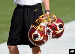 FILE - Washington Redskins football helmets are seen before a game in Landover, Md., Aug. 19, 2016. The Supreme Court could decide to hear a case this term centering on whether trademarks deemed offensive to some can be canceled.