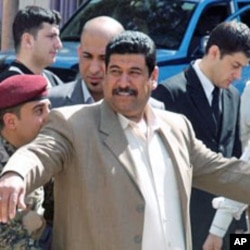 A Baghdad voter is searched before entering a polling station, 07 Mar 2010