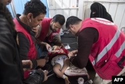 Syrian medics treat a baby at a makeshift clinic at the internally displaced persons camp of al-Hol in al-Hasakah governorate in northeastern Syria, Feb. 6, 2019.