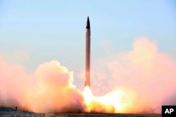 This photo released by the official website of the Iranian Defense Ministry on Sunday, Oct. 11, 2015, claims to show the launching of an Emad long-range ballistic surface-to-surface missile in an undisclosed location.